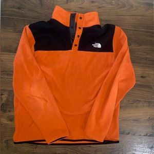 Men’s orange and black north face pull over with buttons.